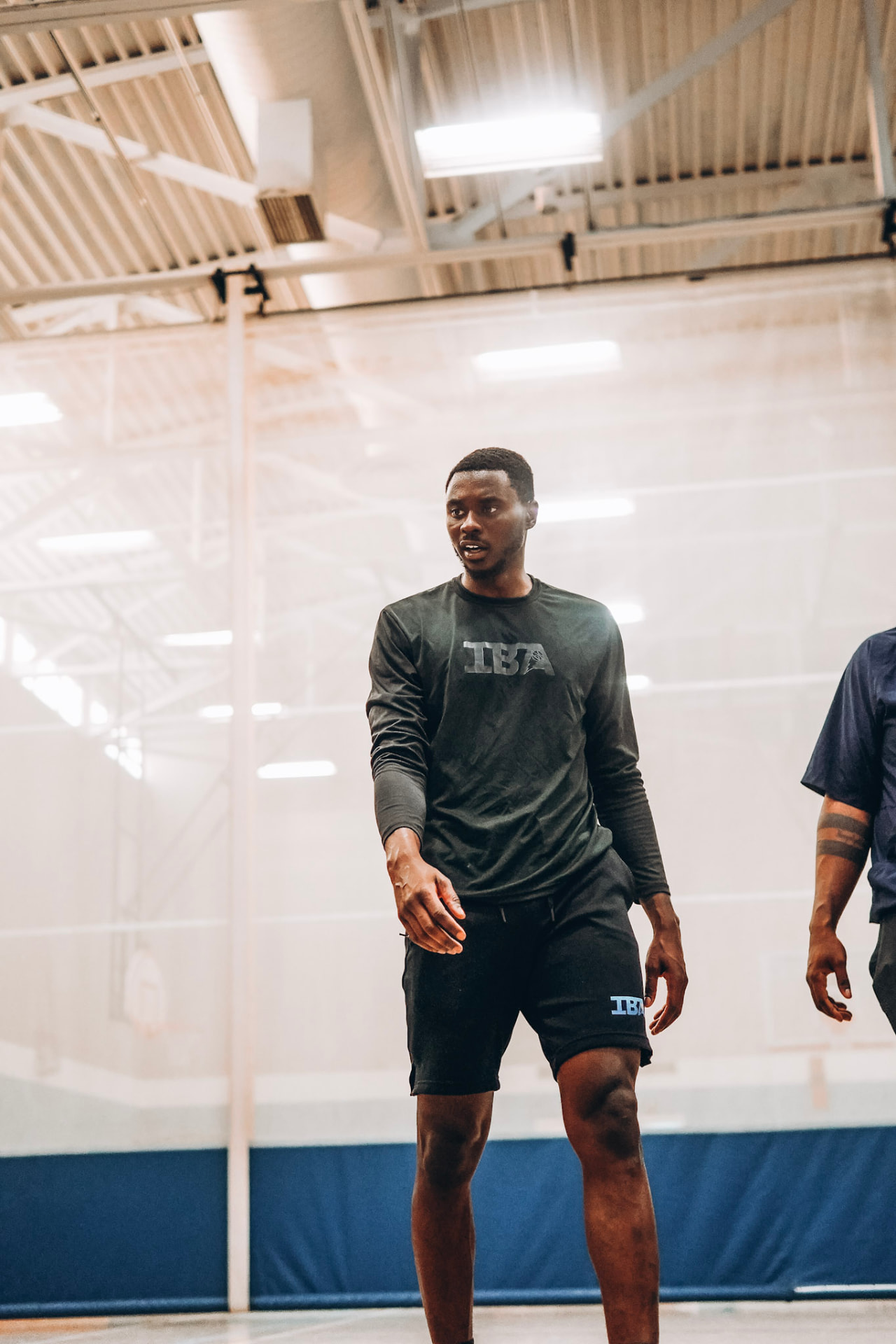 Terry Nolan Jr. in IBA training gear coaching on the court